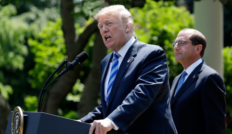 President Donald Trump speaks during an event about prescription drug prices with Health and Human Services Secretary Alex Azar, right, in the Rose Garden of the White House, Friday May 11, 2018, in Washington.