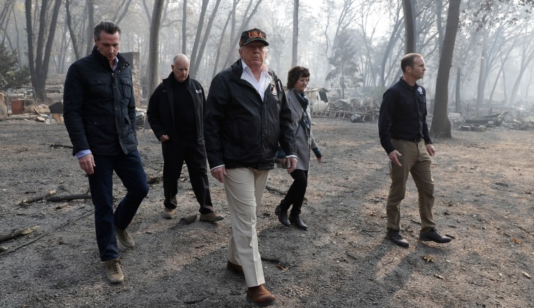 President Donald Trump tours Paradise, Calif., with Gov.-elect Gavin Newsom, California Gov. Jerry Brown, Paradise Mayor Jody Jones and FEMA Administrator Brock Long, right, during a visit to a neighborhood impacted by the wildfires, Saturday, Nov. 17, 2018, in Paradise, Calif.