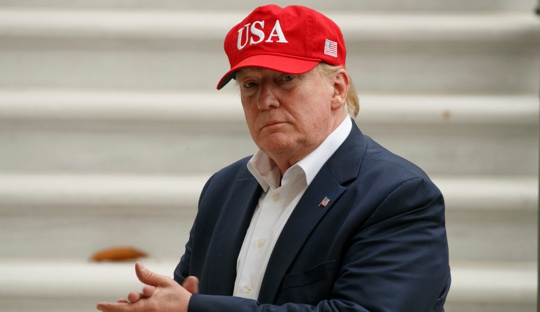 President Donald Trump claps after greeting supporters waiting at the White House with first lady Melania Trump as they returned to the White House, Friday June 7, 2019, in Washington.