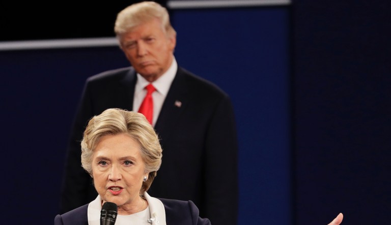 Republican presidential nominee Donald Trump listens to Democratic presidential nominee Hillary Clinton during the second presidential debate at Washington University in St. Louis, Sunday, Oct. 9, 2016.
