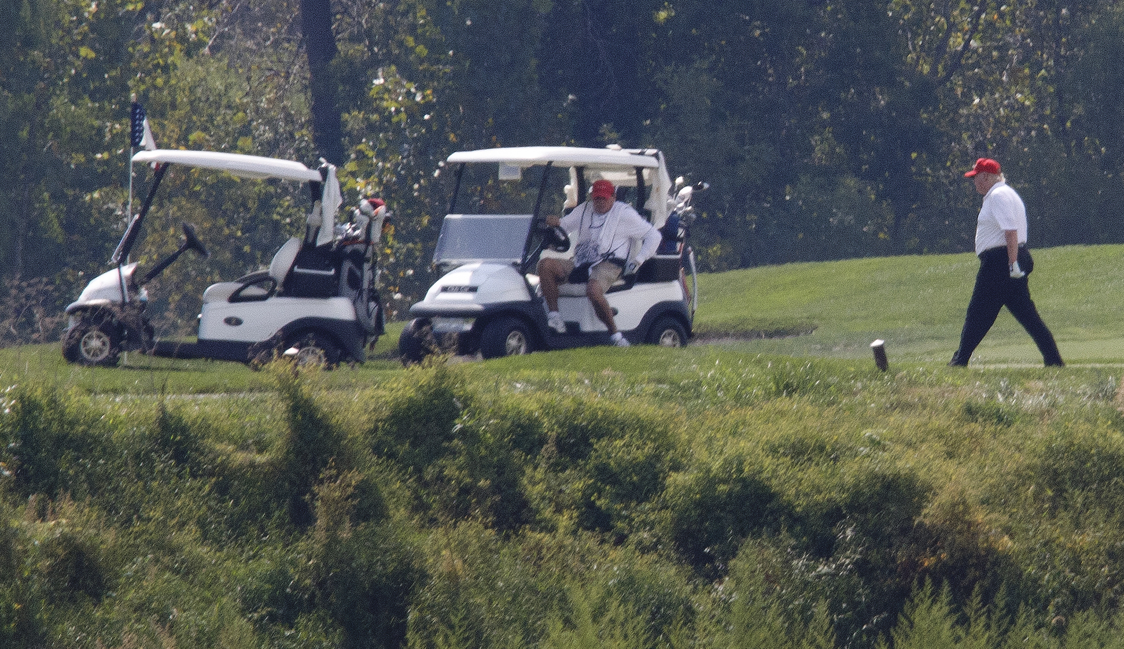 Trump defends golf outings as US coronavirus death toll nears 100,000