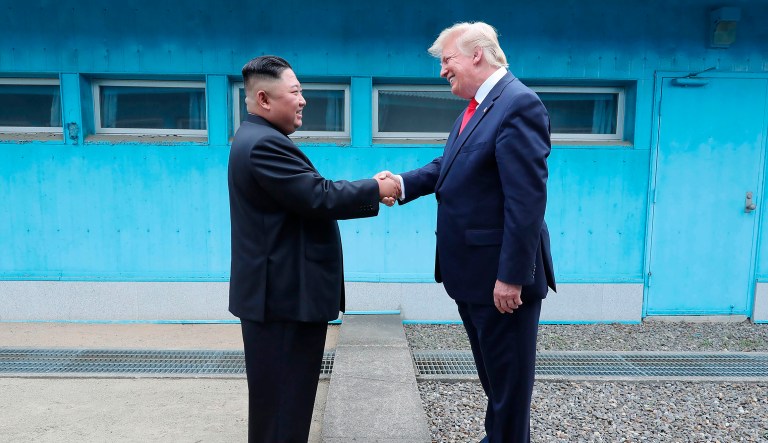 In this Sunday, June 30, 2019, photo provided by the North Korean government, North Korean leader Kim Jong Un, left, and President Trump shake hands over the military demarcation line at the border village of Panmunjom in Demilitarized Zone. 