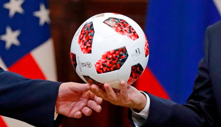 Russian President Vladimir Putin, right, gives a soccer ball to U.S. President Donald Trump, left, during a press conference after their meeting at the Presidential Palace in Helsinki, Finland, Monday, July 16, 2018.