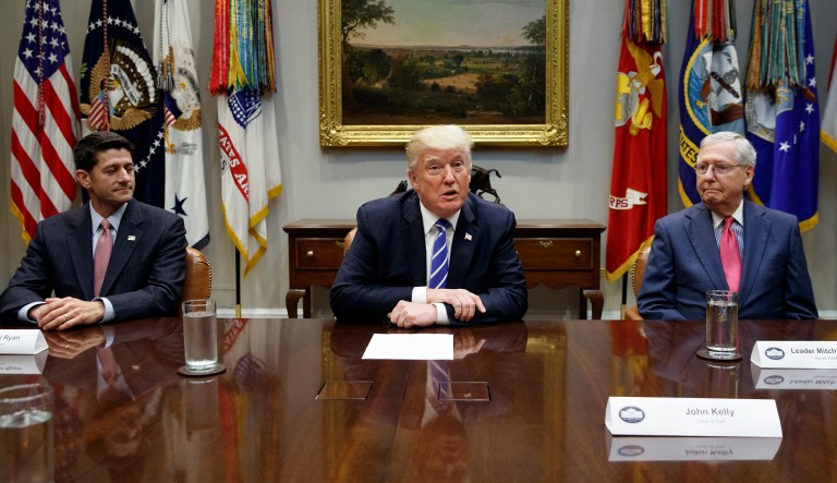 FILE - In this Sept. 5, 2017, file photo, House Speaker Paul Ryan, R-Wis., left, and Senate Majority Leader Mitch McConnell, R-Ky., right, listen as President Donald Trump speaks during a meeting with Congressional leaders and administration officials on tax reform, in the Roosevelt Room of the White House in Washington.