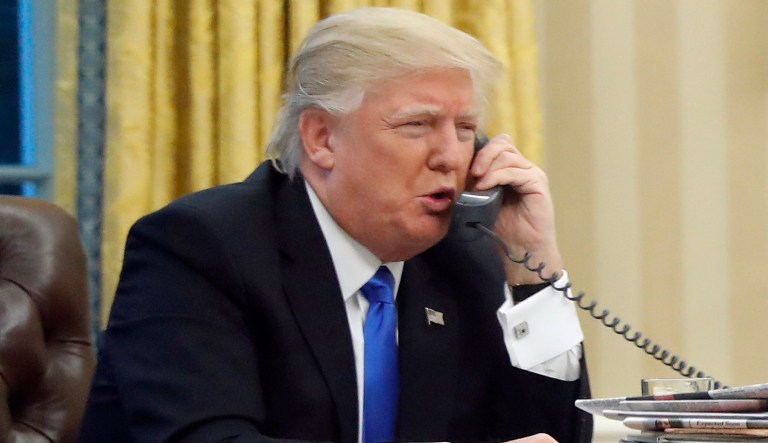 FILE - In this Jan. 28, 2017, file photo, President Donald Trump speaks on the phone with Prime Minister of Australia Malcolm Turnbull in the Oval Office of the White House in Washington. Trump, who blasted Hillary Clinton for using a personal email server, might be a walking magnet for eavesdropping and malware if he is using an unsecured cellphone to chat with foreign leaders. Trump has been handing out his cellphone number to counterparts around the world, urging them to call him directly to avoid the red tape of diplomatic communications. The practice has raised concern about the security and secrecy of the U.S. commander-in-chief's communications.