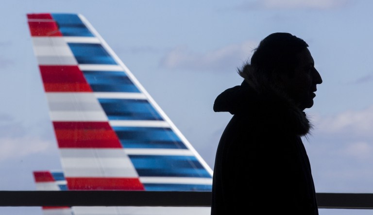 A traveler walks past airplanes at Ronald Reagan National Airport (DCA) in Arlington, Virginia, U.S., on Monday, Dec. 24, 2018. 