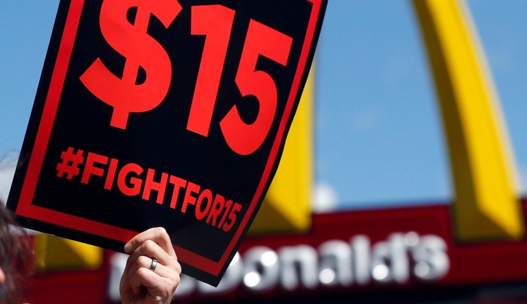 In this July 22, 2015 file photo, supporters of a $15 minimum wage for fast food workers rally in front of a McDonald's in Albany, N.Y.
