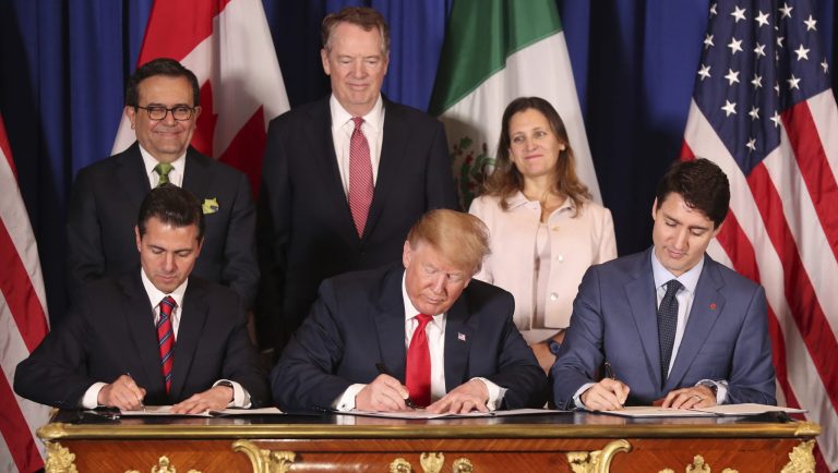 President Donald Trump, center, sits between Canada's Prime Minister Justin Trudeau, right, and Mexico's President Enrique Pena Nieto as they sign a new United States-Mexico-Canada Agreement that is replacing the NAFTA trade deal, during a ceremony at a hotel before the start of the G20 summit in Buenos Aires, Argentina, Friday, Nov. 30, 2018. The USMCA, as Trump refers to it, must still be approved by lawmakers in all three countries. 