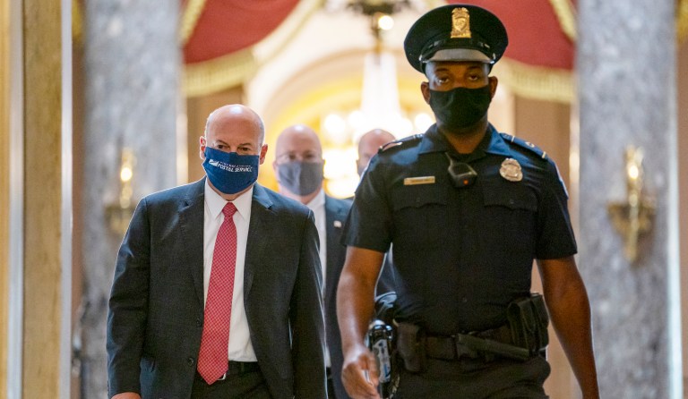Postmaster General Louis DeJoy, left, is escorted to House Speaker Nancy Pelosiâs office on Capitol Hill in Washington, Wednesday, Aug. 5, 2020. Some clarity is beginning to emerge from the bipartisan Washington talks on a huge COVID-19 response bill. An exchange of offers and meeting devoted to the Postal Service on Wednesday indicates the White House is moving slightly in House Speaker Nancy Pelosiâs direction on issues like aid to states and local governments and unemployment insurance benefits. But the negotiations have a long ways to go.