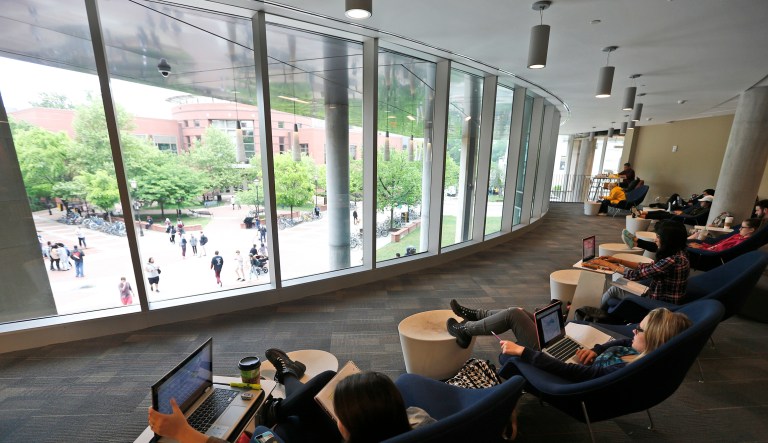 Students look out over the campus as they work on computers at the renovated James Branch Cabell library on the campus of Virginia Commonwealth University  in Richmond, Va., Thursday, April 28, 2016. 