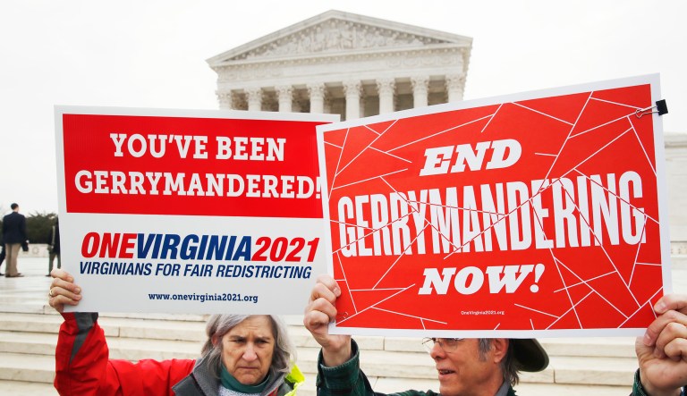 Sara Fitzgerald, left, and Michael Martin, both with the group One Virginia, protest gerrymandering in front of the Supreme Court, Wednesday, March 28, 2018, in Washington where the court will hear arguments on a gerrymandering case. The Supreme Court is taking up its second big partisan redistricting case of the term amid signs the justices could place limits on drawing maps for political gain.