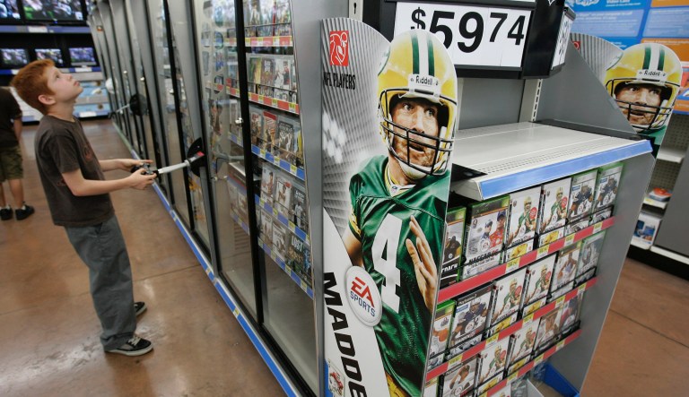 Walmart customer plays on a video game as the new Electronic Arts game Madden 2009 on display at Walmart in San Jose, Calif., Wednesday, Aug. 13, 2008. 