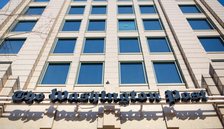 FILE - In this Dec. 11, 2015 file photo, the One Franklin Square Building in Washington, that houses the Washington Post newspaper.  The Washington Post is featuring a new motto on the paper's website: "Democracy Dies in Darkness." The words now appear underneath the name of the paper on its website. They were not, however, in a similar place in the paper's print edition Wednesday, Feb. 22, 2017. Amazon.com founder and CEO Jeff Bezos used the phrase in an interview last year when asked to explain why he purchased the paper in 2013.