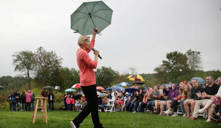Democratic presidential candidate Sen. Elizabeth Warren, D-Mass., gestures with an umbrella as she speaks at a campaign event, Monday, Sept. 2, 2019, in Hampton Falls, N.H. (AP Photo/Elise Amendola)