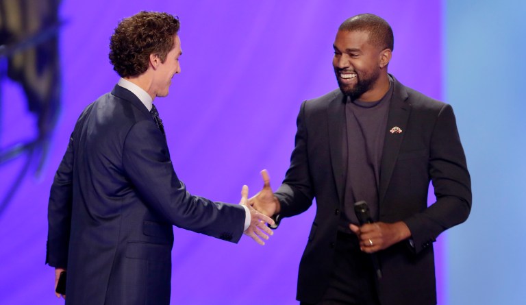 Kanye West, right, shakes hands with senior pastor Joel Osteen during a service at Lakewood Church, Sunday, Nov. 17, 2019, in Houston. 