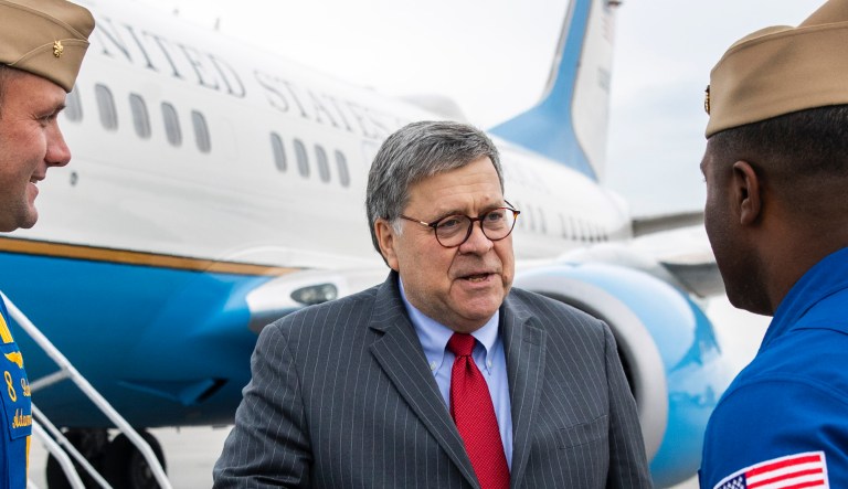 Attorney General William Barr speaks with Lt. Commander Adam Kerrick, left, and Lt. Julius Bratton of the U.S. Navy Blue Angels flight demonstration team before boarding an aircraft at Burke Lakefront Airport, Thursday, Nov. 21, 2019, in Cleveland. Barr participated in a roundtable discussion with members of local, state and federal law enforcement, and is en route to Montana, where he is scheduled Friday to address missing and murdered indigenous persons.