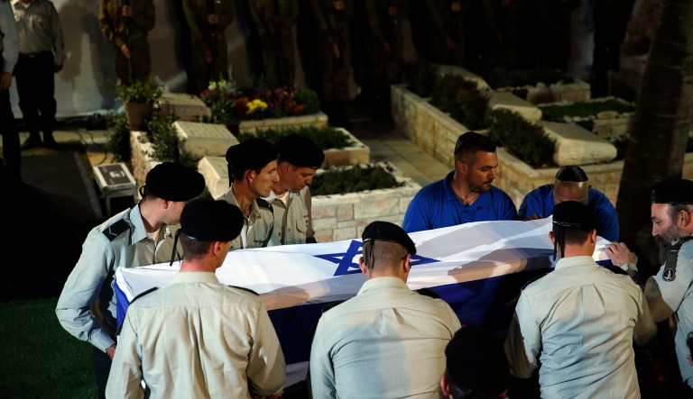 Israeli soldiers carry the coffin with the remains of Zachary Baumel, during his funeral at the Mt. Herzel military cemetery in Jerusalem, Thursday, April 4, 2019. 