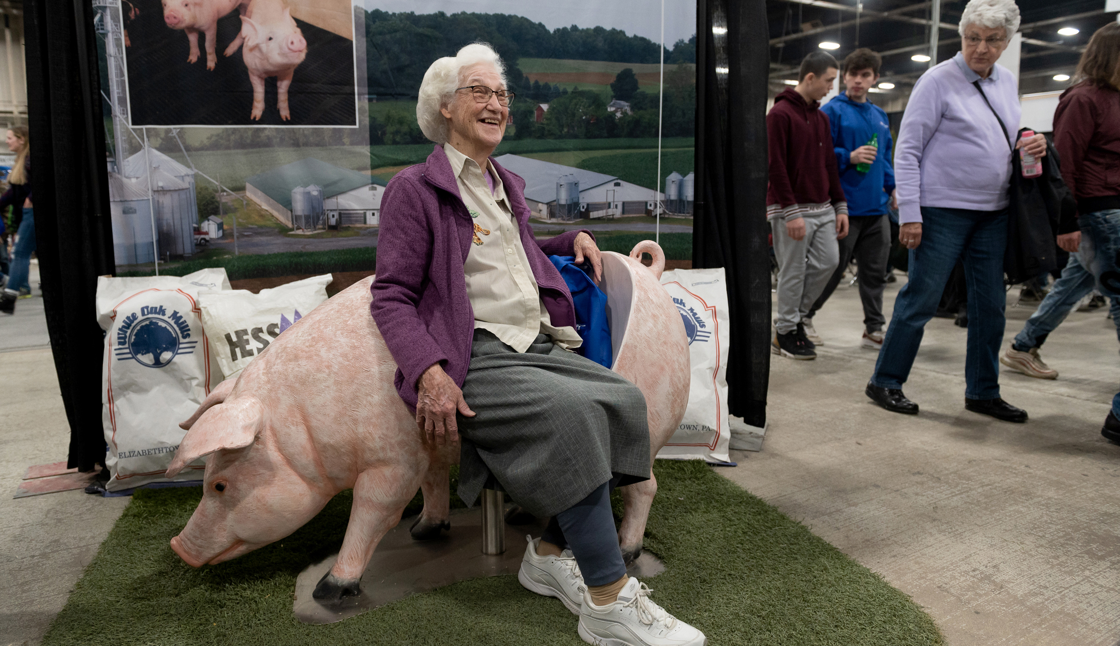 Beatrice Gyger, 89, of Hummelstown, Pennsylvania, sits on a pig seat at the 104th Pennsylvania Farm Show in Harrisburg. 