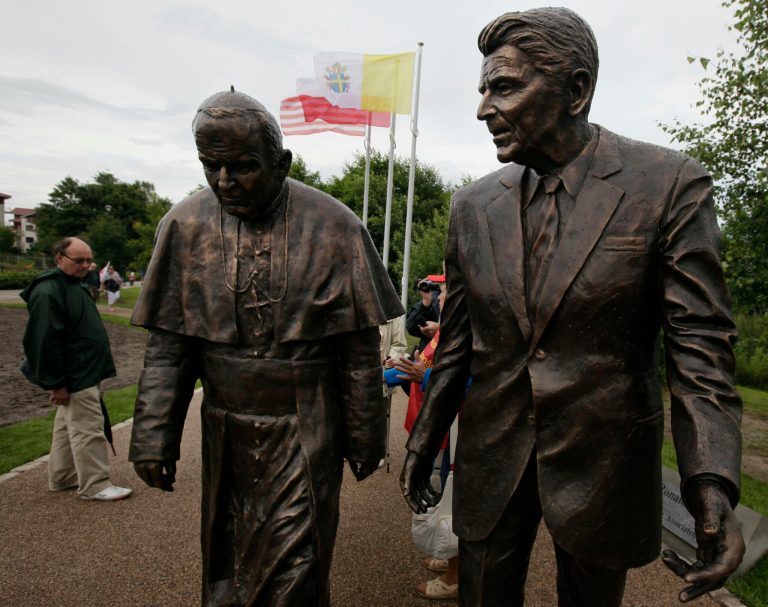 People look at a new statue of former President Ronald Reagan and Pope John Paul II that was unveiled in Gdansk, Poland, on Saturday, July 14, 2012. The statue honors the two men whom many Poles credit with helping to topple communism. (AP Photo/Czarek Sokolowski)