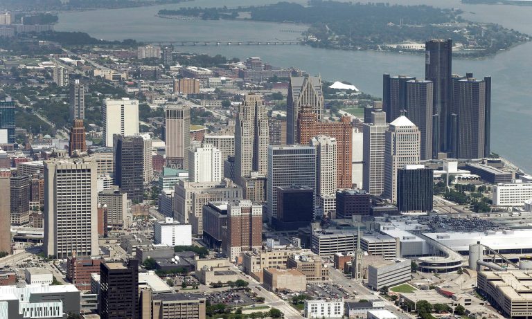 In this July 16, 2013 aerial file photo, the downtown of the city of Detroit is shown. Detroit Emergency Manager Kevyn Orr raised more than a few eyebrows a year ago when he took the city into bankruptcy and predicted it would be out by the time his term expired in fall 2014. Because it is by far the largest city to file for municipal bankruptcy and the issues were so complex many experts predicted it would take years to resolve. But the city will take a major step toward that goal with a trial in federal bankruptcy court that starts Tuesday, Sept 2, 2014. (AP Photo/Paul Sancya, File)