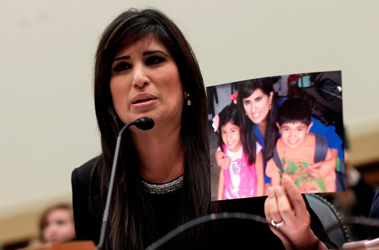 Naghmeh Abedini, wife of Pastor Saeed Abedini, holds up a photo of her children as she testifies before the House Foreign Affairs Committee on Dec. 12 in Washington, D.C.ÃÂ Iranian authorities transferred Saeed into a ward reserved for political prisoners, a slight improvement over his previous detainment with violent criminals, Naghmeh said on Jan. 22, though he remains in endangered physical condition.ÃÂ (Photo by Win McNamee/Getty images)