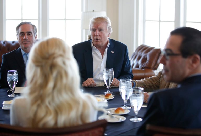 President Donald Trump, center, meets Treasury Secretary Steven Mnuchin, right, and Secretary of Veterans Affairs David Shulkin, left, along with other members of his cabinet and the White House staff, Saturday, March 11, 2017, at the Trump National Golf Club in Sterling, Va. (AP Photo/Manuel Balce Ceneta)