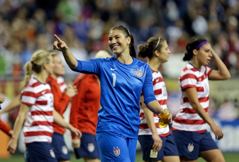   United State's goalkeeper Hope Solo points the crowd after beating China 2-0 in a international friendly soccer match at Ford Field in Detroit, Saturday, Dec. 8, 2012. (AP Photo/Paul Sancya)  