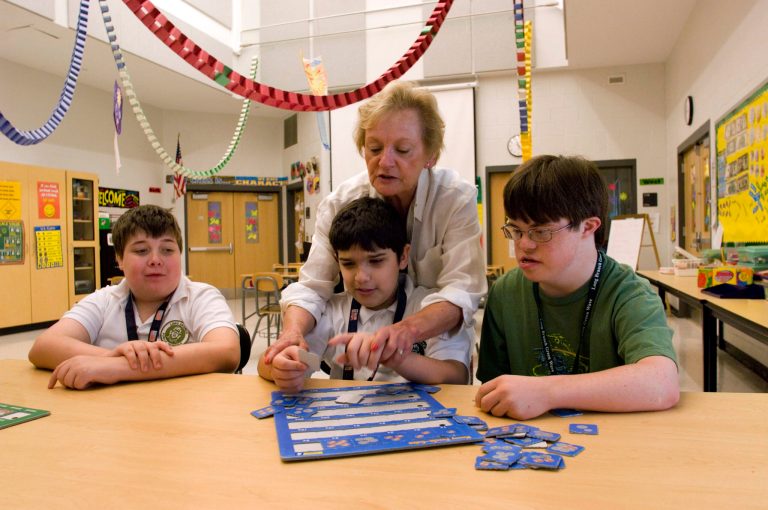 Special education teacher Karen Hansen works with students during a money counting exercise in a 6-8 grade class at the Long Branch Middle School in Long Branch, N.J., Friday, June 1, 2007. (AP Photo/Colin Archer)