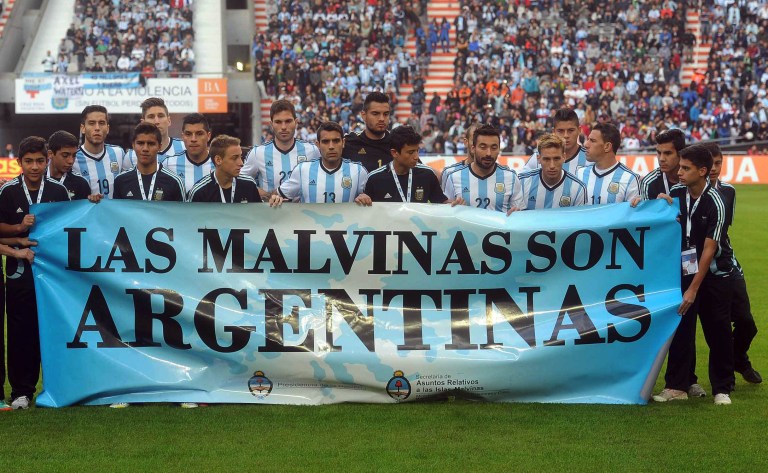 Argentina's team poses for a picture with a banner reading in Spanish 