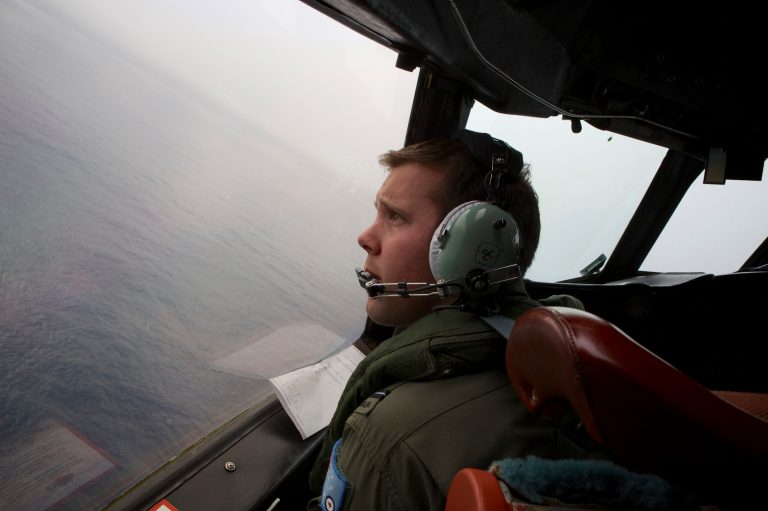FILE - In this March 24, 2014 file photo, co-pilot, flying officer Marc Smith turns his Royal Australian Air Force AP-3C Orion aircraft at low level in bad weather whilst searching for missing Malaysia Airlines Flight 370 over the Indian Ocean. The Australian government plans to spend 90 million Australian dollars ($84 million) on the search for the missing Malaysian plane. Australia is leading the search for the missing plane, which is thought to have disappeared in the Indian Ocean with 239 people aboard on March 8. Budget documents released Tuesday, May 13, 2014 showed that the government has budgeted AU$90 million for the search in the current fiscal year through June and next fiscal year. (AP Photo/Richard Wainwright, Pool, File)