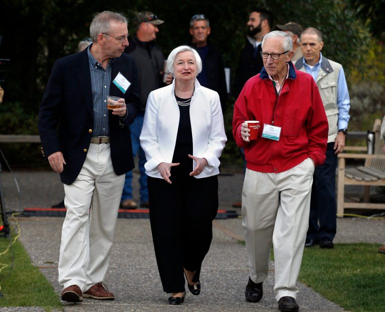 The Federal Reserve, led by Chairwoman Janet Yellen (center), must decide whether and how much to raise key interest rates. Vice Chairman Stanley Fischer, right, is warning that one small hike is not enough, and that the Fed must decide a pace at which to slowly ratchet up rates. Fed officials met in Wyoming over the weekend for their annual policy conference. (AP Photo/Brennan Linsley)