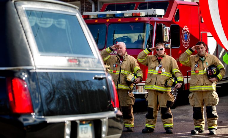   Firefighters salute as a hearse passes for the funeral procession to the burial of 7-year-old Sandy Hook Elementary School shooting victim Daniel Gerard Barden, Wednesday, Dec. 19, 2012, in Newtown, Conn. Barden was killed when Adam Lanza walked into Sandy Hook Elementary School in Newtown, Conn., Dec. 14, and opened fire, killing 26 people, including 20 children, before killing himself. (AP Photo/David Goldman)  