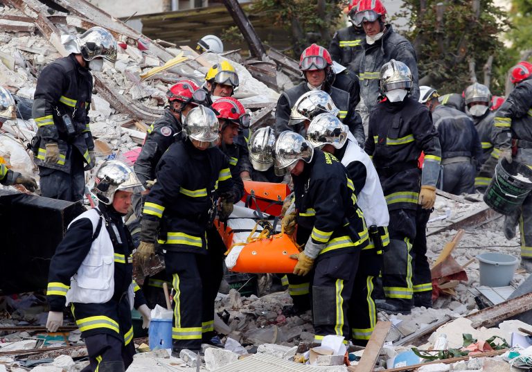 French firemen carry a victim in the rubble of a building after an explosion collapsed it, in Rosny-sous-Bois, outside Paris, Sunday, Aug. 31, 2014. French authorities say a four-story building in a northeastern Paris suburb has collapsed after an explosion, killing a child. More people are thought to underneath the rubble. Speaking on i-Tele, fire department spokesman Gabriel Plus said around 10 people were evacuated from the building in Rosny-sous-bois that occurred early Sunday morning. Plus said that around another 10 people could still be underneath the rubble, and emergency teams were working hard to rescue people who might be trapped. 
