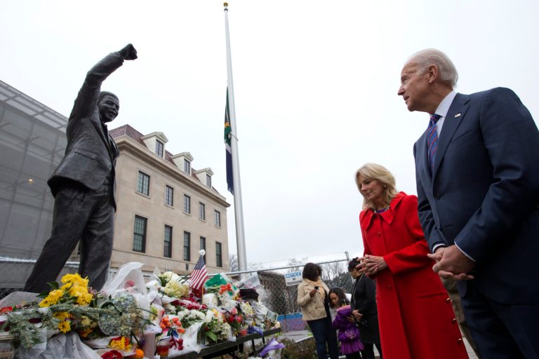 Vice President Joe Biden, right, and wife Jill Biden, pay their respects to former South African President Nelson Mandela outside the South African embassy in Washington, Monday, Dec. 9, 2013, after signing a condolence book inside. While gazing at a statue of Mandela, Biden said that the former president was, 