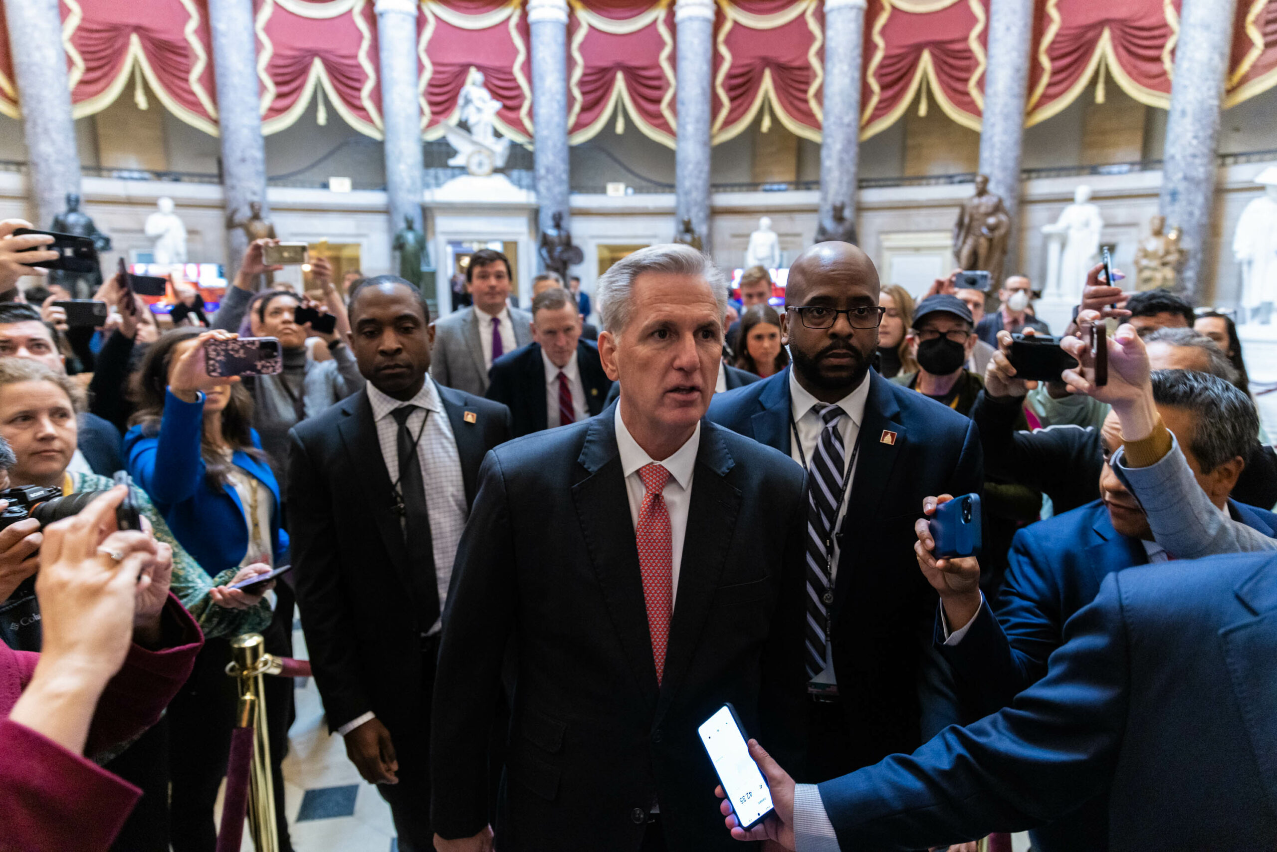 Republican leader Kevin McCarthy walks to the house chamber surrounded by reporters and security, on Wednesday, Jan. 5, 2023. McCarthy has suffered multiple bids for Speaker at the hands of a group of Republican dissidents.