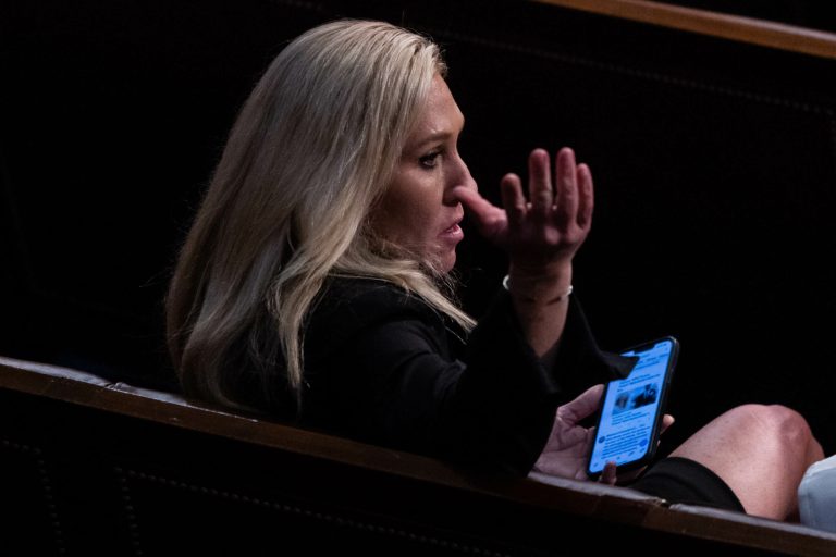 Rep.-elect Marjorie Taylor Greene of Georgia gestures to a colleague on the House floor, following another round of voting for a new House Speaker on the first day of the 118th Congress, Tuesday, Jan. 3, 2023. The House reconvened after failing to elect a speaker Tuesday on three straight ballots.