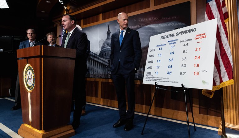 Senator Rick Scott (R-FL) looks at a sign displaying the current U.S. Federal spending, during a news conference on the the debt limit, Wednesday, Jan. 25, 2023. The U.S. hits its debt ceiling, currently $31.4 trillion, on Jan. 19.