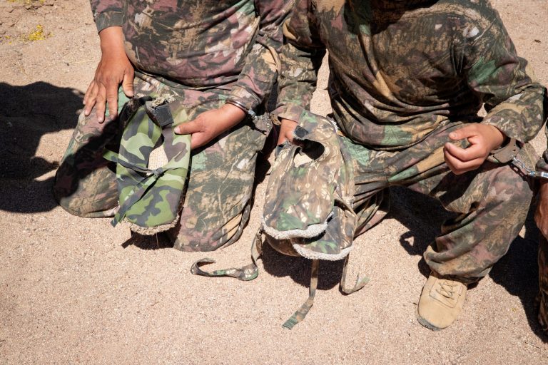 Illegal immigrants wearing camouflage and carpet on the bottom of their shoes in hopes of avoiding detection.