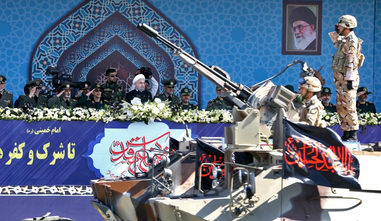Iran's President Hassan Rouhani, center, reviews a military parade during the 37th anniversary of Iraq's 1980 invasion of Iran, in front of the shrine of the late revolutionary founder, Ayatollah Khomeini, just outside Tehran, Iran, Friday, Sept. 22, 2017. Iran's Revolutionary Guard has unveiled its latest ballistic missile with a range of 2,000 kilometers -- about 1,250 miles-- capable of reaching much of the Middle East, including Israel. (AP Photo/Ebrahim Noroozi)