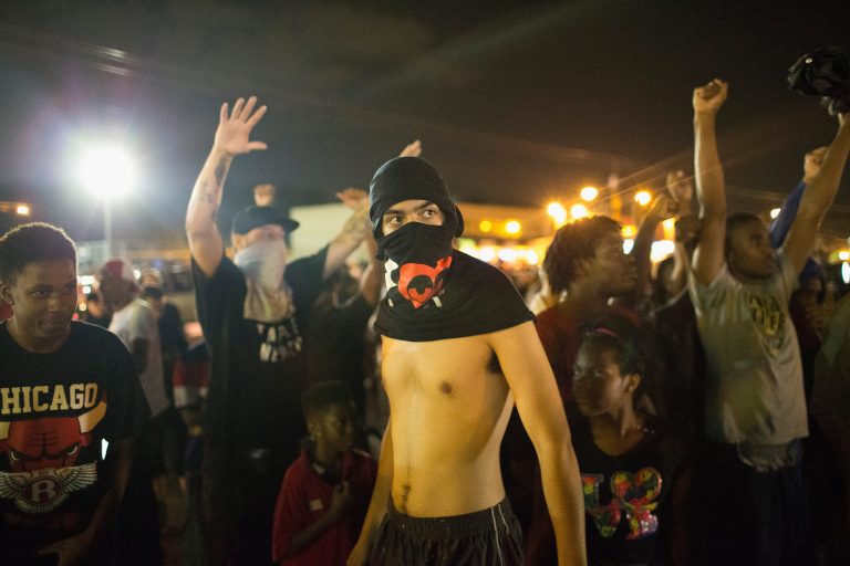 Demonstrators, marking the one-year anniversary of the shooting of Michael Brown, face off with police during a protest along West Florrisant Street on August 9, 2015 in Ferguson, Mo. (Photo by Scott Olson/Getty Images)