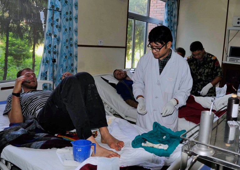 In this Thursday, Oct. 16, 2014 photo released by Nepalese Army, unidentified survivors of an avalanche are treated at Army Hospital in Katmandu, Nepal. Rescuers widened their search Friday for trekkers stranded since a series of blizzards and avalanches battered the Himalayas in northern Nepal early this week leaving at least 29 people killed, officials said. (AP Photo/Nepalese Army)