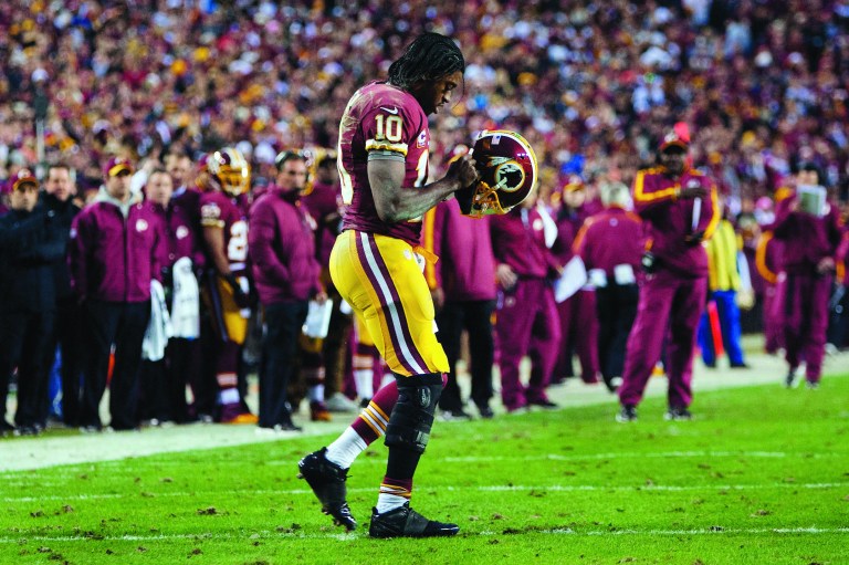 LANDOVER, MD - JANUARY 06:   Robert Griffin III #10 of the Washington Redskins runs the ball for a first down against the Seattle Seahawks during the NFC Wild Card Playoff Game at FedExField on January 6, 2013 in Landover, Maryland.  (Photo by Patrick McDermott/Getty Images)