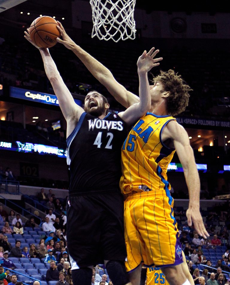   New Orleans Hornets center Robin Lopez (15) blocks a shot by Minnesota Timberwolves forward Kevin Love (42) in the first half of an NBA basketball game in New Orleans, Friday, Dec. 14, 2012. (AP Photo/Gerald Herbert)  