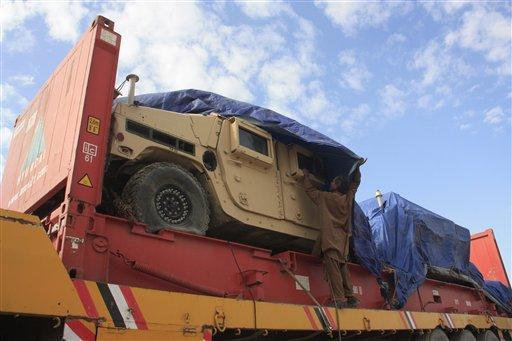 A Pakistani driver covers a NATO vehicle parked at Pakistani border Chaman which was closed for NATO supply trucks on Monday, Nov 28, 2011. The border closure is in response to NATO airstrikes that killed 24 Pakistani soldiers. 