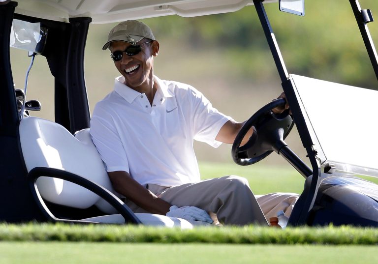 President Obama smiles as he sits at the wheel of a golf cart while golfing at Vineyard Golf Club in Edgartown, Mass., on the island of Martha's Vineyard, Wednesday. (AP Photo/Steven Senne)