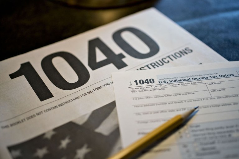 U.S. Department of the Treasury Internal Revenue Service (IRS) 1040 Individual Income Tax forms for the 2017 tax year sit on a table. 