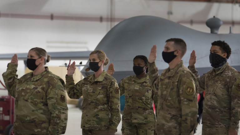 Holloman Air Force Base and Fort Bliss, Texas, Airmen take the Oath of Enlistment during U.S. Space Force transfer ceremony, Feb. 12, 2021, on Holloman AFB, New Mexico. A total of 18 Airmen were chosen to transfer over to the U.S. Space Force. 