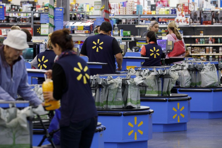 Cashiers ring up shoppers at a Walmart Inc. store in Burbank, California, U.S., on Monday, Nov. 19, 2018. To get the jump on Black Friday selling, retailers are launching Black Friday-like promotions in the weeks prior to the event since competition and price transparency are forcing retailers to grab as much share of the consumers' wallet as they can. 
