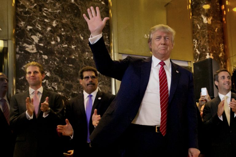 Republican presidential candidate Donald Trump is applauded by his son Eric Trump, left, as he arrives for a news conference at Trump Tower, in New York, Thursday, Sept. 3, 2015. (AP Photo/Richard Drew)