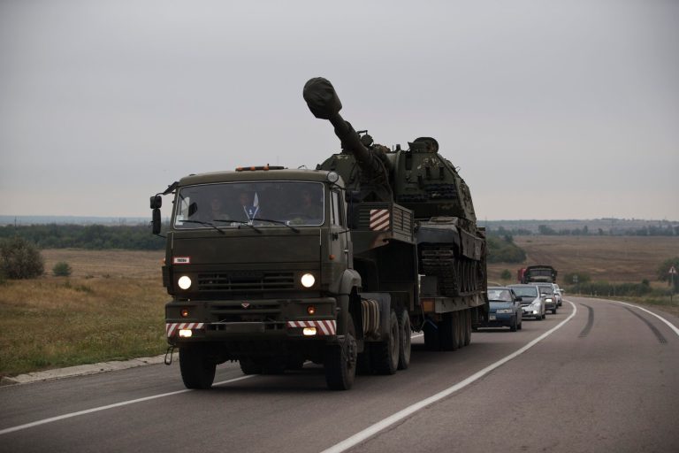 A Russian military truck carries a MSTA-S self-propelled howitzer about 10 kilometers from the Russia-Ukrainian border control point at town Donetsk, Rostov-on-Don region, Russia, Tuesday, Aug. 19, 2014. Ukrainian government troops were fighting pro-Russian rebels in the streets of Luhansk on Tuesday and captured most of a town near the eastern city of Donetsk, tightening the noose around that key rebel-held stronghold, Ukrainian officials said. (AP Photo/Pavel Golovkin)